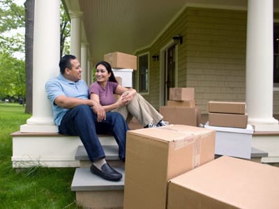 Couple on porch with moving boxes